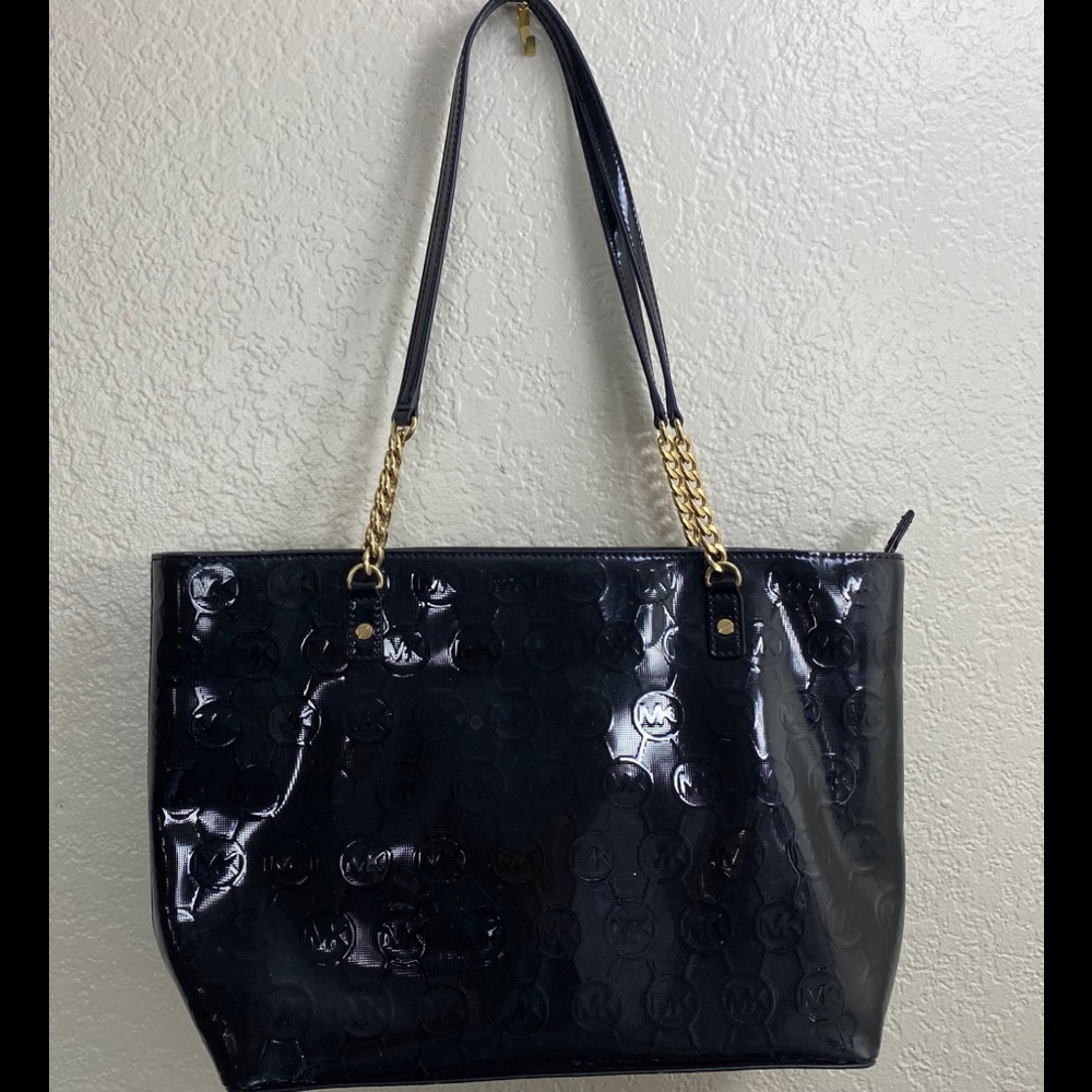 Black Michael Kors  purse with gold chain.